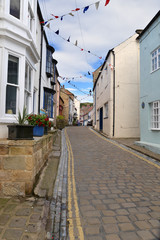 Narrow cobbeld street and houses in Staithes, Yorkshire, UK