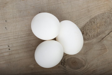 heap of chicken eggs on wooden background