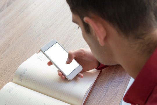 young hand with mobile phone and Notepad or book