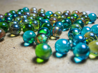 Colored glass balls scattered on a wooden surface
