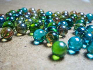Colored glass balls scattered on a wooden surface
