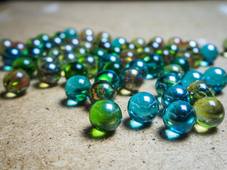 Colored glass balls scattered on a wooden surface