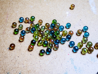 Colored glass balls scattered on a wooden surface
