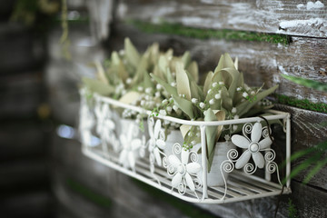 floral arrangement of potted plants and artificial flowers