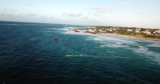 Kite surfer riding in Barbados on a beautiful sunny day.