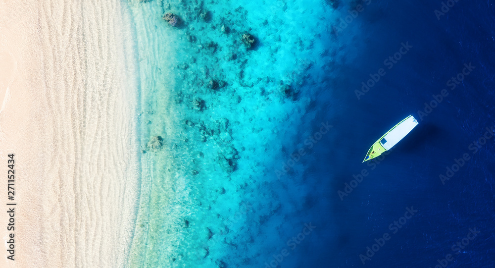 Wall mural boat on the water surface from top view. turquoise water background from top view. summer seascape f