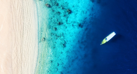 Boat on the water surface from top view. Turquoise water background from top view. Summer seascape...