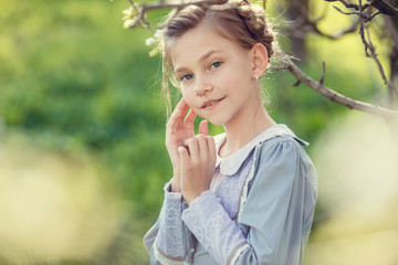 Fototapeta premium Beautiful cute girls in the garden, enjoying the arrival of spring, dresses in vintage style