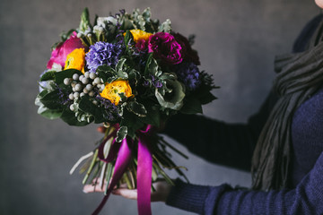 Beautiful bouquet of flowers in the hands of a woman