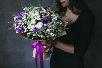 Beautiful bouquet of flowers in the hands of a woman