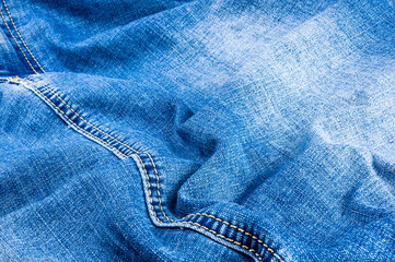 clothing items blue stonewashed faded jeans cotton fabric texture with seams, clasps, buttons and...