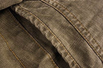 clothing items stonewashed cotton fabric texture with seams, clasps, buttons and rivets, macro