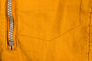 clothing items stonewashed cotton fabric texture with seams, clasps, buttons and rivets, macro