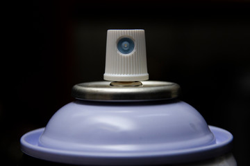 Spray paint can nozzle closeup picture