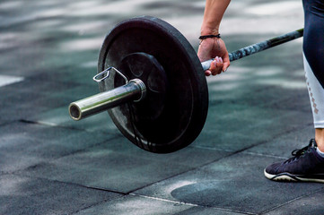 crossfit woman preparing for her weightlifting workout with a heavy dumbbell