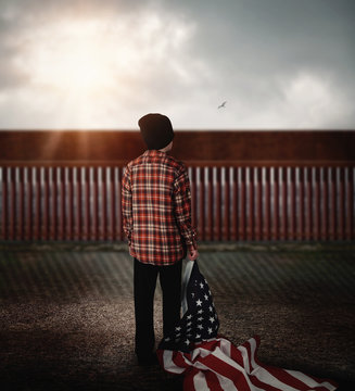 Immigrant Child Looking at Border Wall