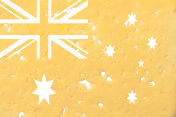 Australia flag cut out of cheese, as a symbol of the import or export of cheese on a white isolated background