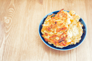 Diet vegetable cutlet from carrot, zucchini, potato on wood table. Healthy food