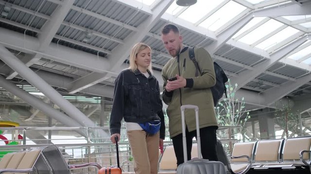 Man and woman with a baggage in airport.