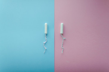 Two tampons on pink and blue backgrounds. copy spase. soft focus.