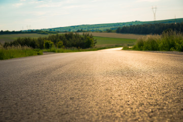 Close up of asphalt on country road. Asphalt texture on empty rural road down the hill