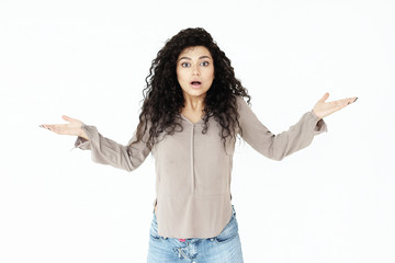 lifestyle,emotion and people concept: surprised young casual girl shrugging shoulders