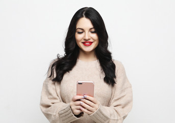 Fashion curvy brunette girl taking photo makes self portrait on smartphone