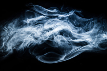 White, blue cigarette smoke on a black background. Stop smoking