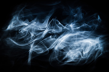 White, blue cigarette smoke on a black background. Stop smoking