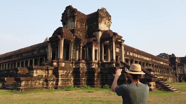 tourist takes a photo of the temple of Angkor Wat, Cambodia.