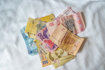 Bundle of Ukrainian money (hryvnia, grivna) in the hands of old man