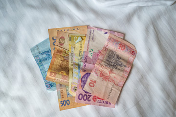 Bundle of Ukrainian money (hryvnia, grivna) in the hands of old man