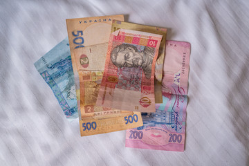 Bundle of Ukrainian money (hryvnia, grivna) in the hands of old man