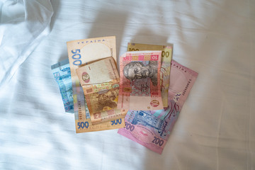 Bundle of Ukrainian money (hryvnia, grivna) in the hands of old man