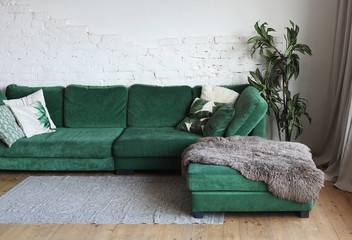 green sofa in the room next to the flowers