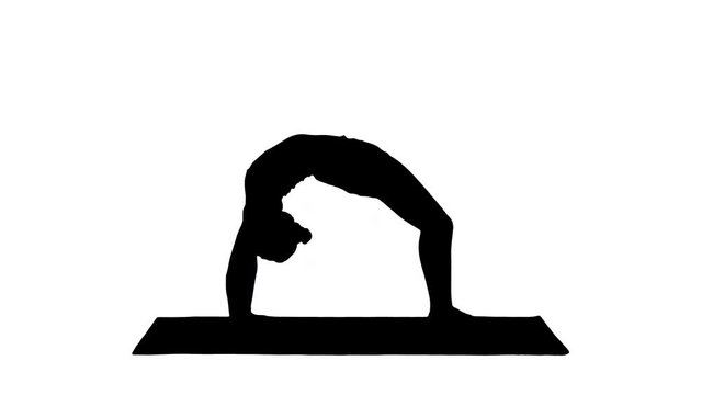 Silhouette Sporty yoga girl performing Chakrasana Urdva Dhanurasana Wheel Pose.