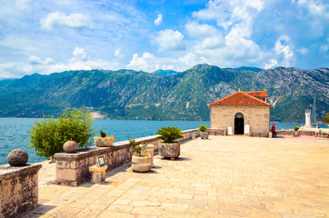 Beautiful mediterranean landscape. Our Lady of the Rock Island near town Perast, Kotor bay, Montenegro.
