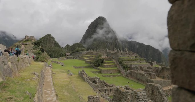Handheld push in shot framing a mountain peak in the ruins of Machu Picchu in Peru