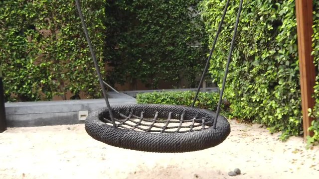 slow motion. lonely swing in motion.