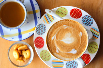 cappuccino coffee served with tea and cookie
