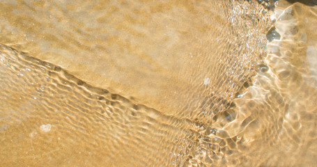 Water flow in the sand background