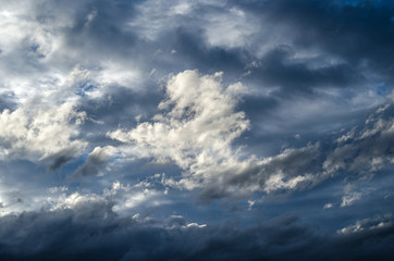 Naklejka na ściany i meble Somber rainy sky with clouds. Weather. Background.