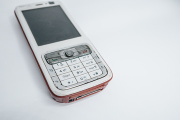 Traditional mobile phone in second generation with keyboard button and mini black and white monitor by white isolate die cut background.  