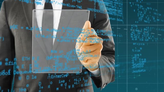Businessman using a futuristic tablet and program codes
