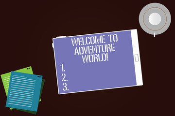 Writing note showing Welcome To Adventure World. Business photo showcasing Enjoyment travelling exploring new places Tourism Tablet Screen Cup Saucer and Filler Sheets on Color Background