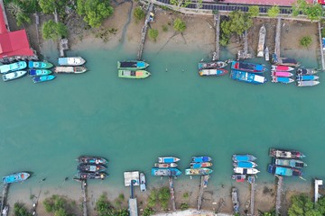 Traditional fishing boats in harbour in Southeast Asia. Aerial photo 