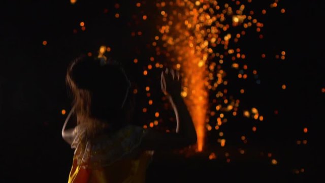 Asian girl look at fireworks and cheerful on a holiday night, slow motion shot