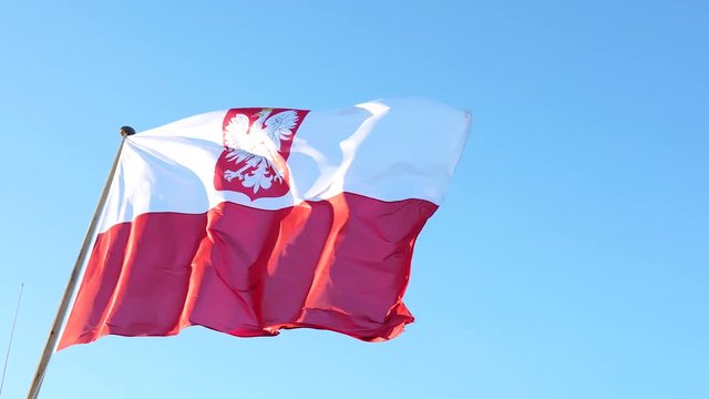 Flag of Poland. Big flag with empble on blue sky.