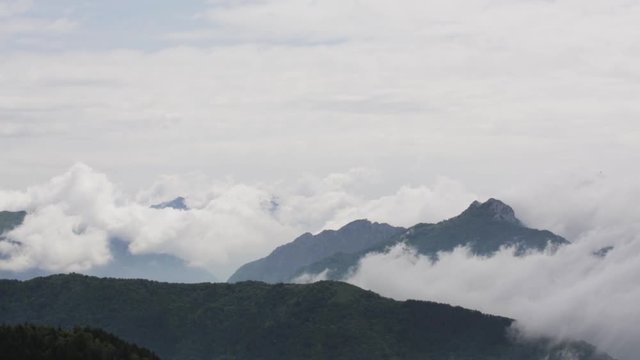 Close up shot with clouds sitting into the mountains, shot in Monte Colma
