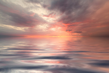 Naklejka na ściany i meble Colorful sea background wallpaper. Sunrise over the sea and beautiful cloudscape. Inspirational calm sea with sunset sky. Meditation ocean and sky background. Colorful horizon over the water.